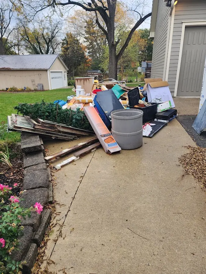 Dumpster being loaded with debris for 12 Yard Dumpster Rental in Kingston